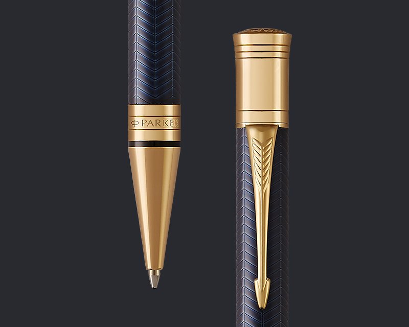 Overhead flat lay closeup of black and gold fountain pen with nib showing and with cover on