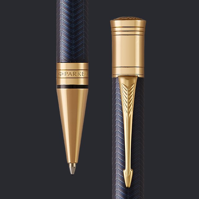 Overhead flat lay closeup of black and gold fountain pen with nib showing and with cover on