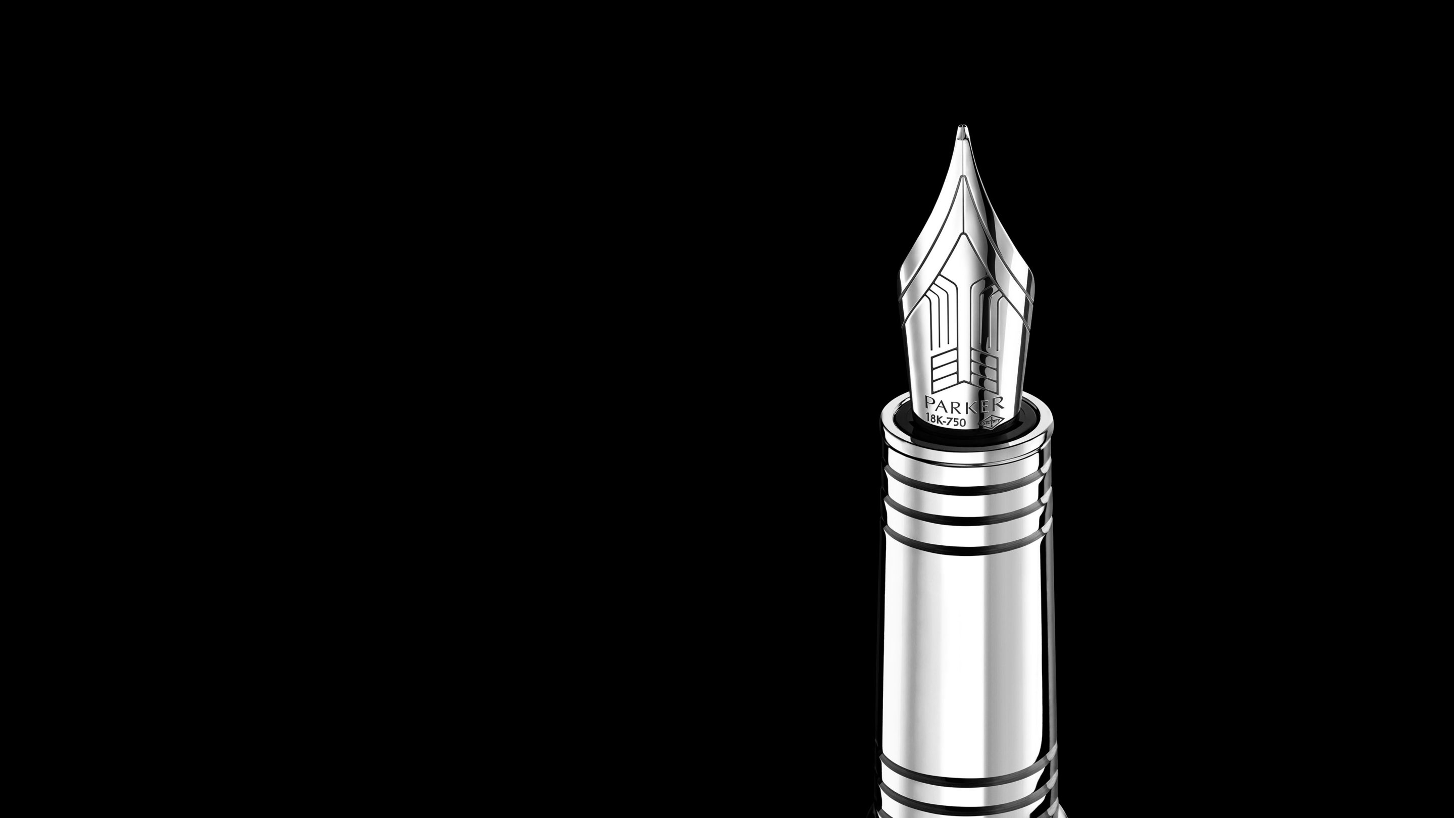 Closeup of an engraved fountain pen nib and barrel.