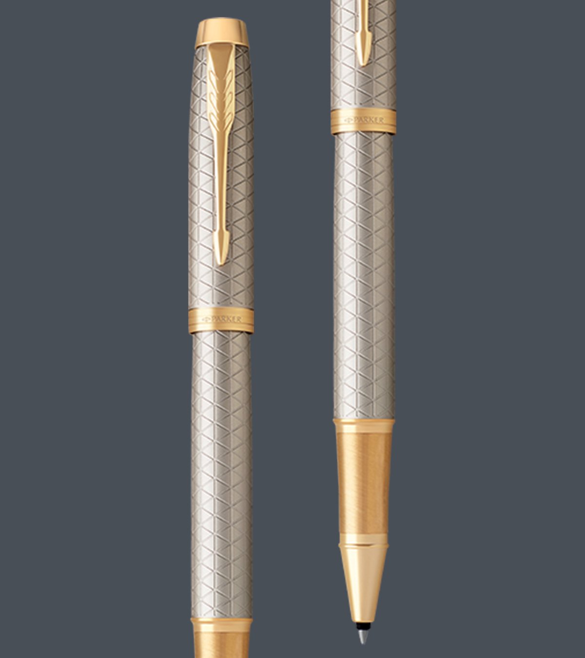Two upright Parker IM rollerball pens with gold trim.