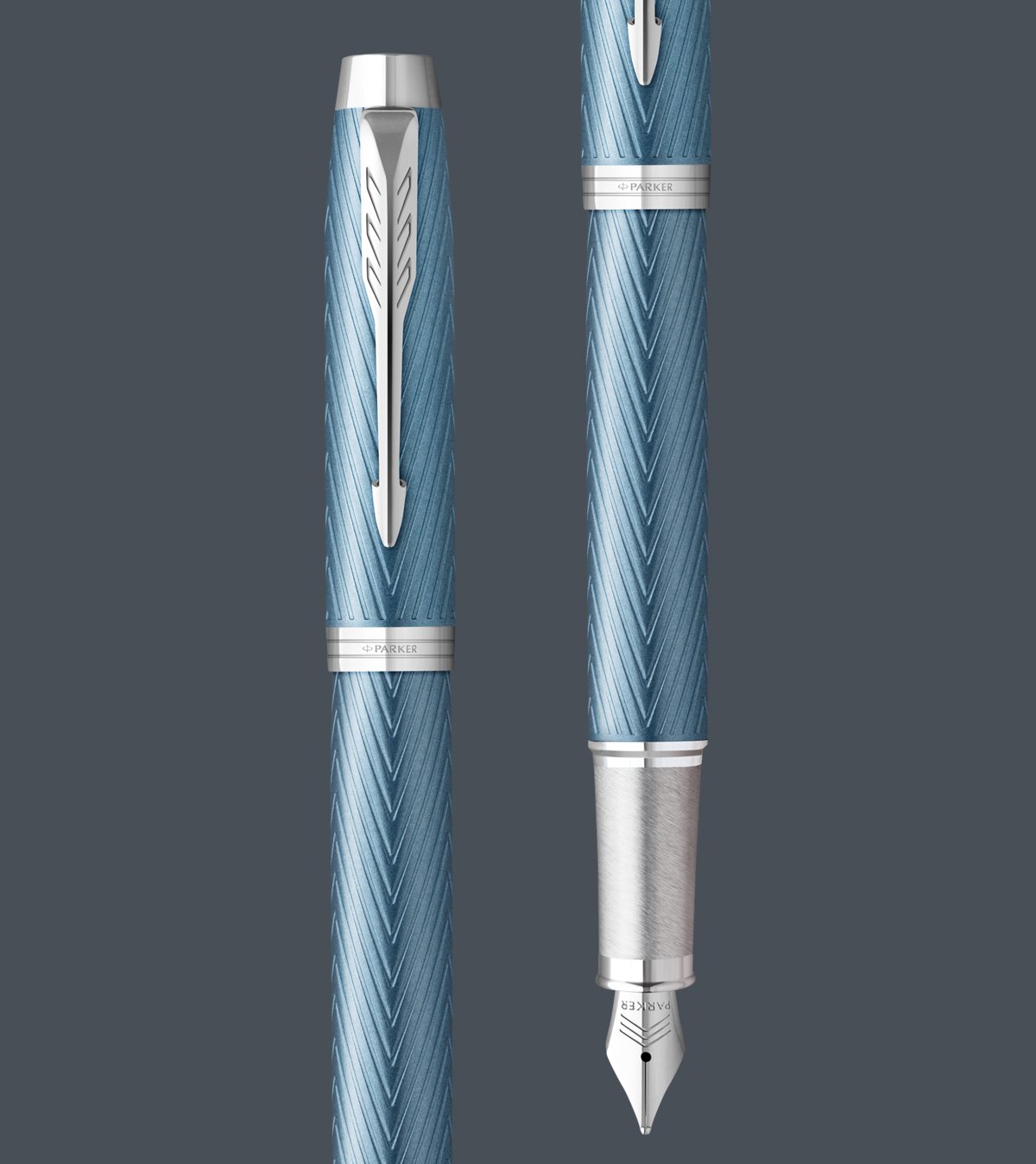 Two upright Parker IM fountain pens with chrome trim.