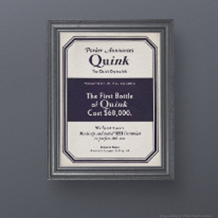 Vintage framed advertisement for Quink ink hung on a wall.