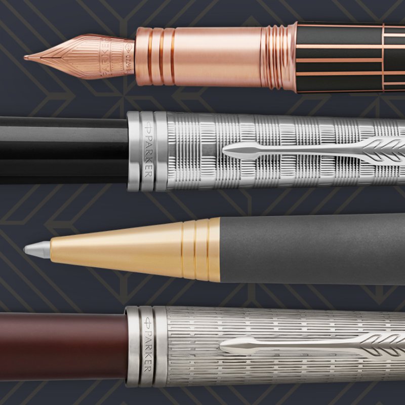 Closeup of a fountain pen nib and barrel, ballpoint tip and barrel and two pen caps.
