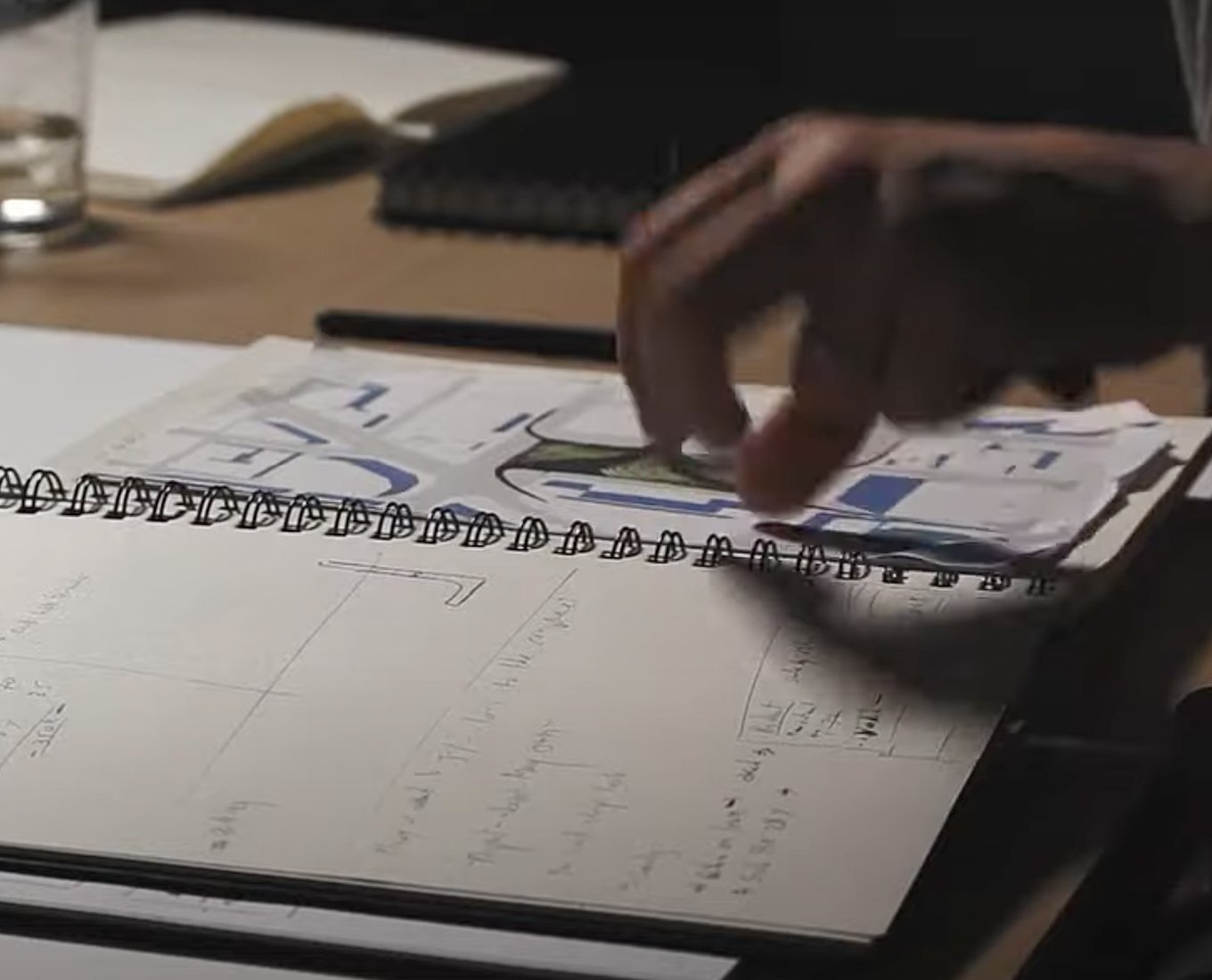 Closeup of a hand flipping through a notebook.