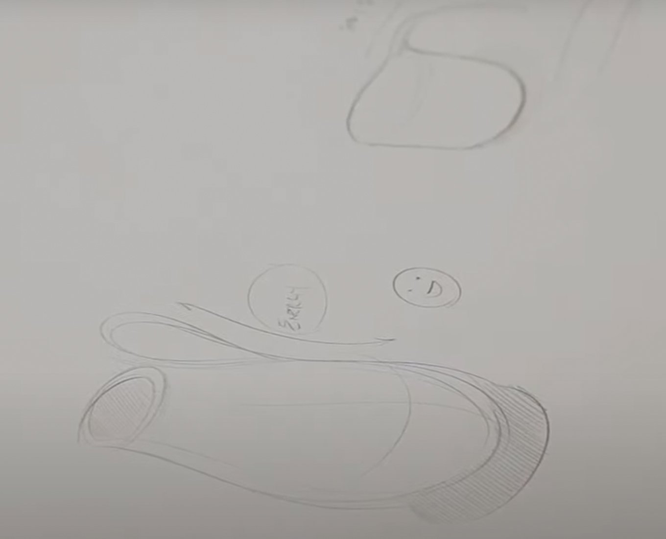 Closeup of a vase and a smiley face pencil sketch.