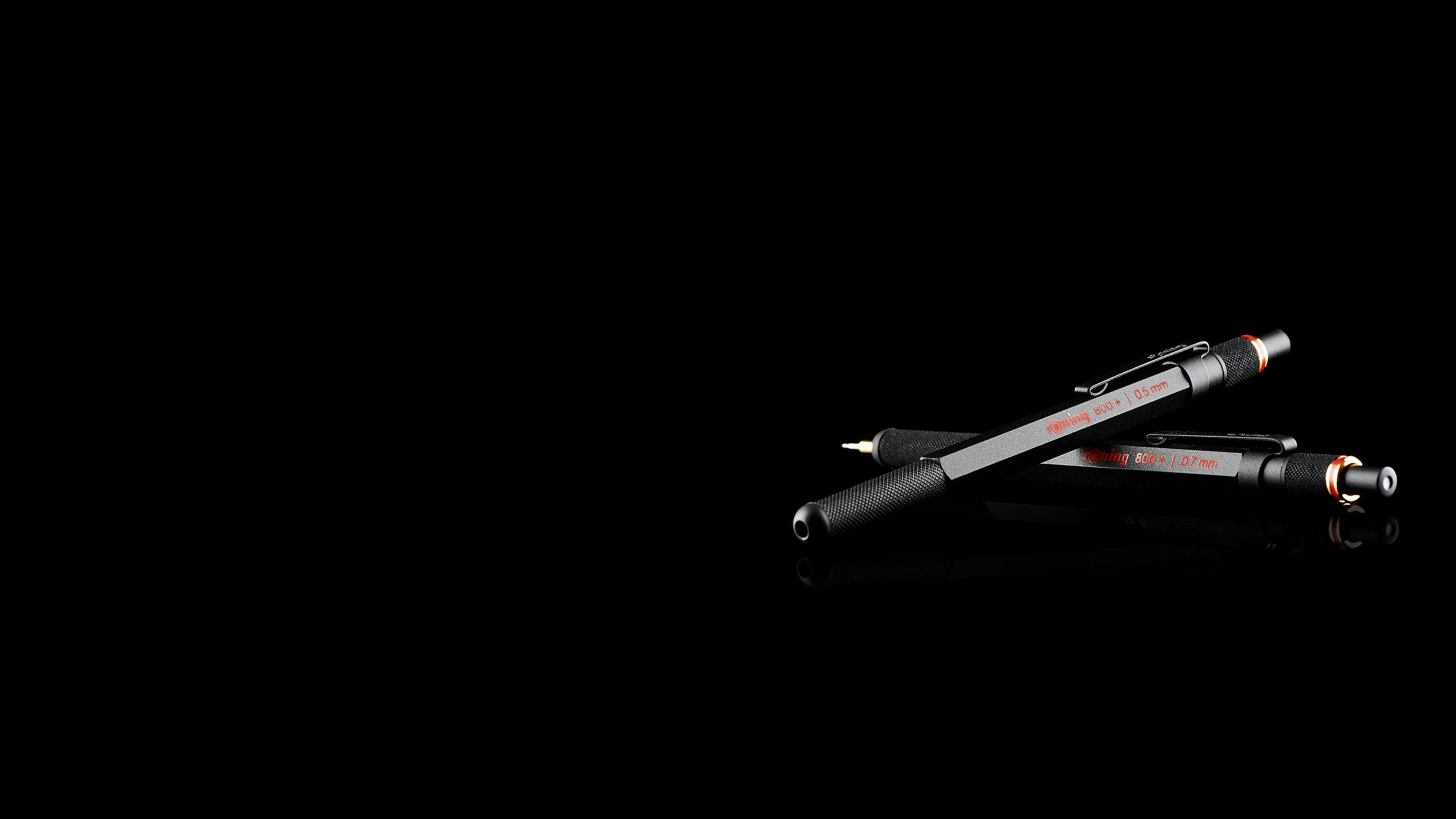 An 800 plus stylus laid over an 800 plus with mechanical pencil tip extended.