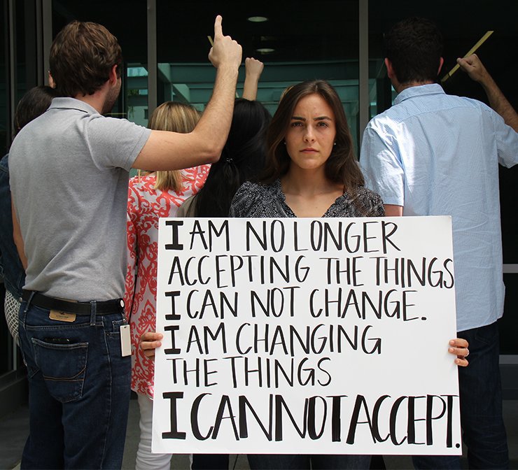 spark change woman with protest sign