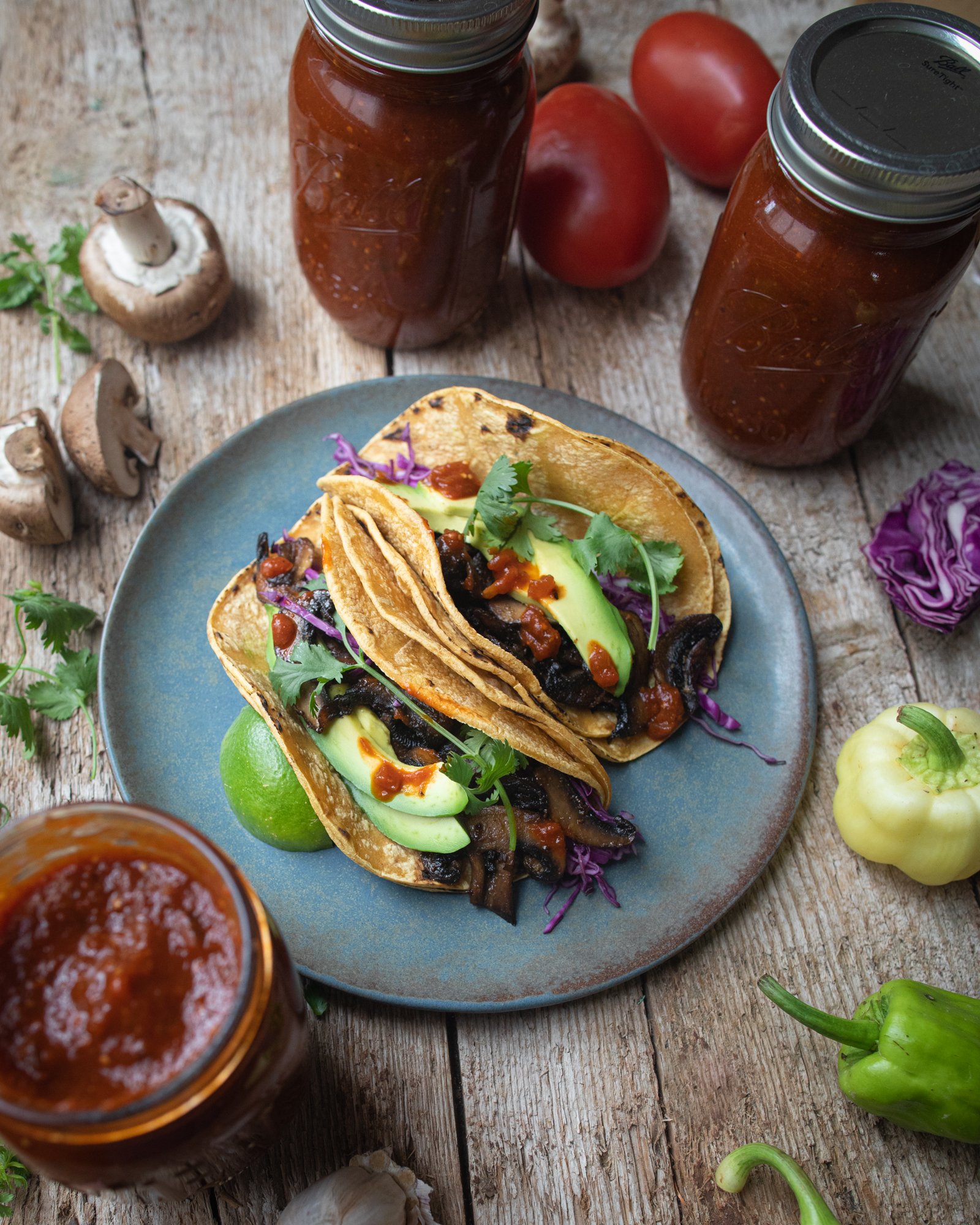plate of tacos with jars of salsa