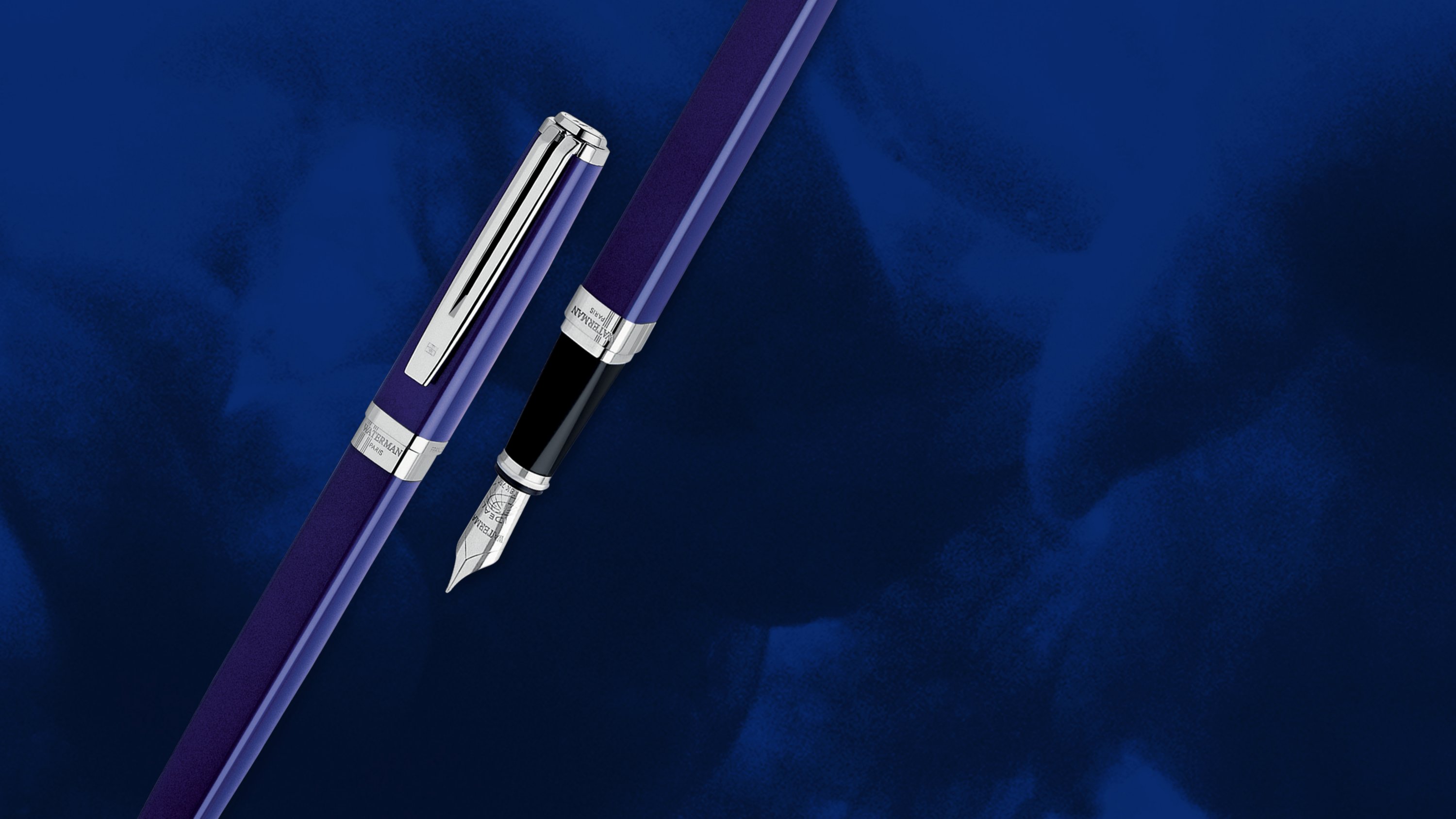 An Exception pen cap next to an Exception fountain pen with chrome trim over a smoky background.