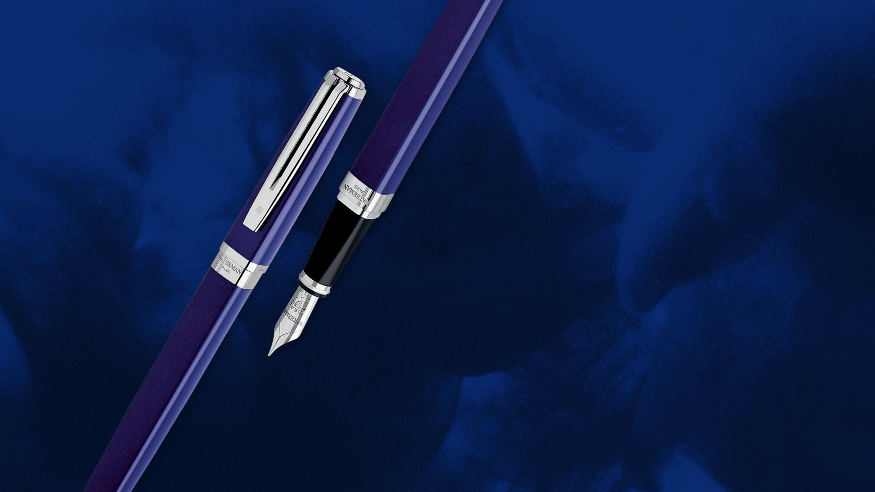 An Exception pen cap next to an Exception fountain pen with chrome trim over a smoky background.