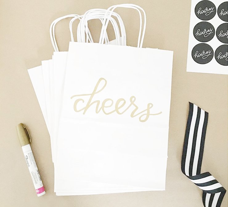 Gold paint pen and decorated gift bags