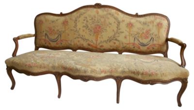 A needlepoint-covered French settee in the late Rococo style.
