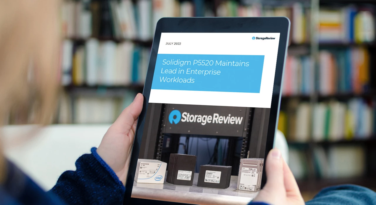 Person holding ipad with StorageReview article titled Solidigm P5520 Maintains Lead in Enterprise Workloads