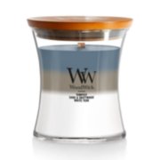 woodwick unchartered waters medium hourglass trilogy candle featuring layered scents of tempest, sand & driftwood, and white teak