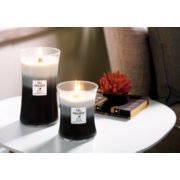 fireside and redwood and sandalwood clove large hourglass trilogy candle on table image number 3