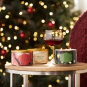 red apple wreath, christmas cookie, and balsam and cedar three-wick candles on table with wine glass image number 4