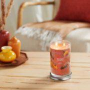 Spiced Pumpkin tumbler candle on table with vases image number 3