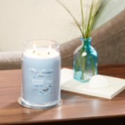 life's a breeze signature large jar candle on table in living room image number 2