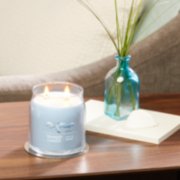 life's a breeze signature medium jar candle on table in living room image number 2