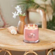 pink sands signature medium tumbler candle on table image number 3