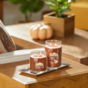 pumpkin banana scone signature large and medium jar candles on table in living room image number 3
