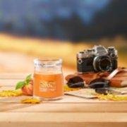 farm fresh peach signature medium jar candle on table image number 4