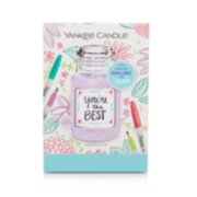 a create your own one-of-a-kind candle label gift set with a candle and a colorful flower design on the front
