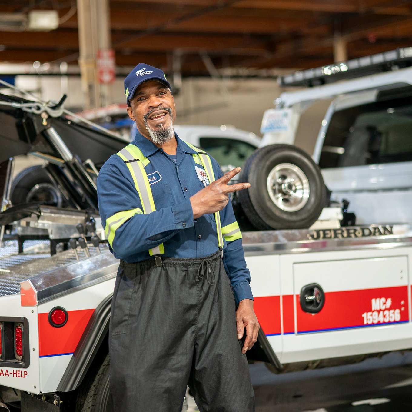 Tow truck driver gives peace sign