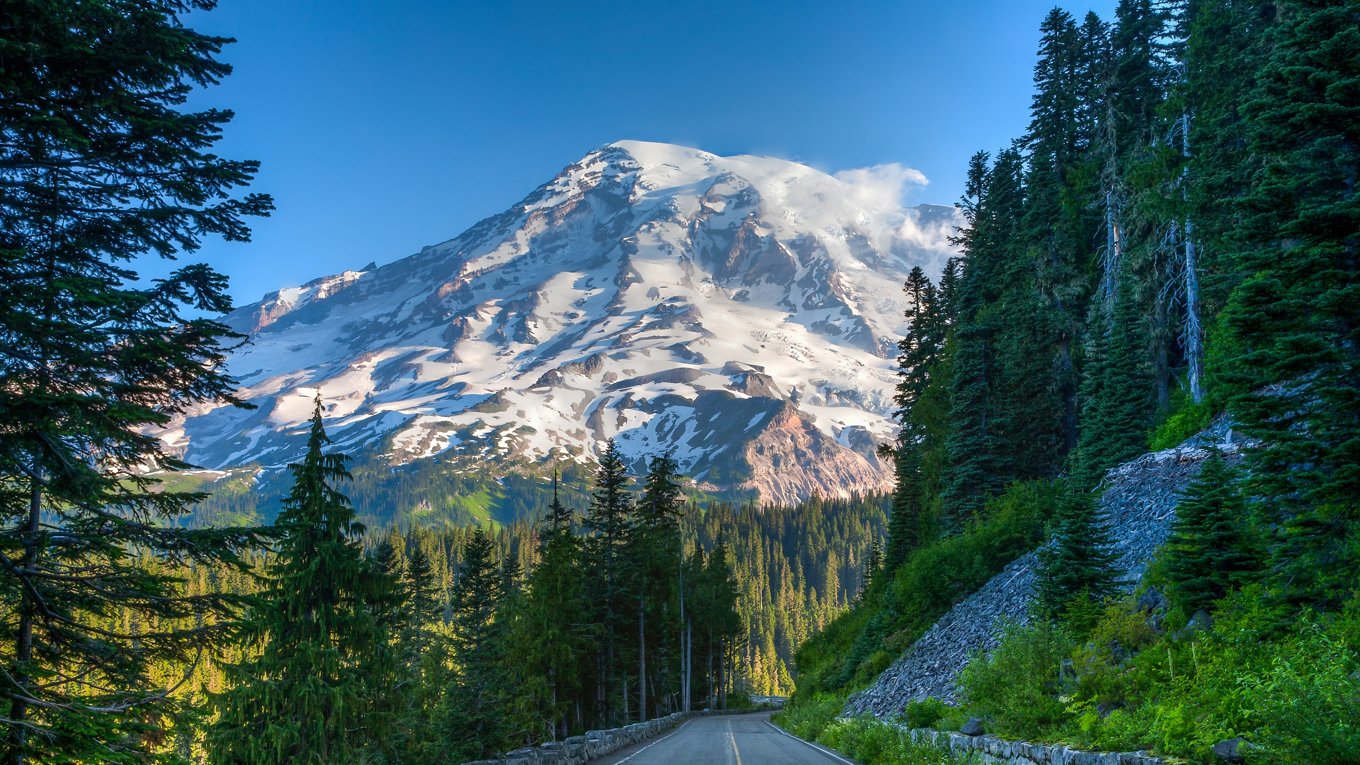 Mt Ranier and park road in Mt Ranier National Park, Washington. Glaciers and snow are visible.