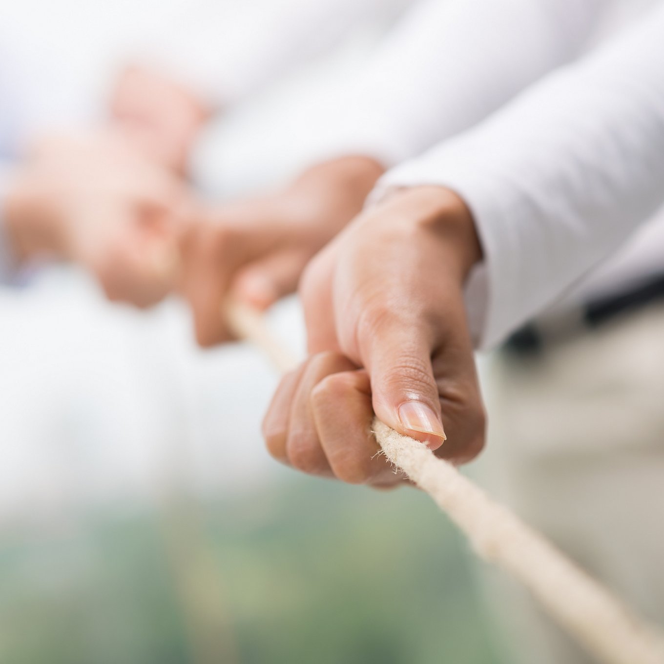 closeup row of hands pulling rope