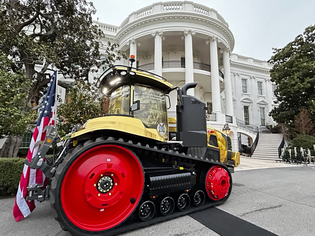 A golden Fendt tracked tractor outside of the White House
