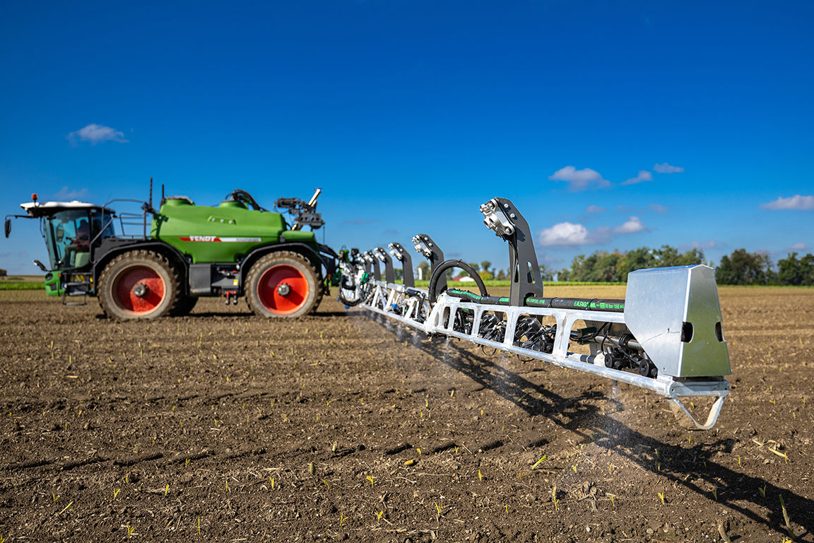 Precision spraying system mounted on a Fendt machine applying targeted crop treatment in a field.