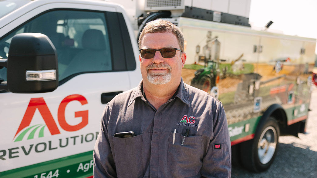 Agrev employee next to truck