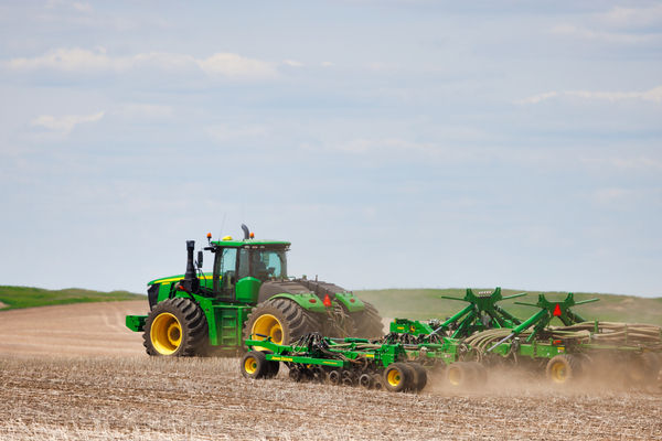 A tractor and seeder in the field