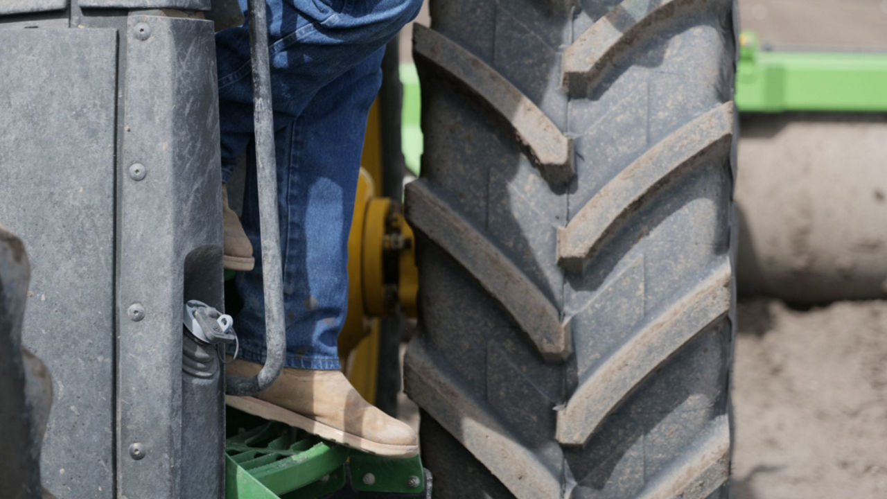 Man climbing down from tractor