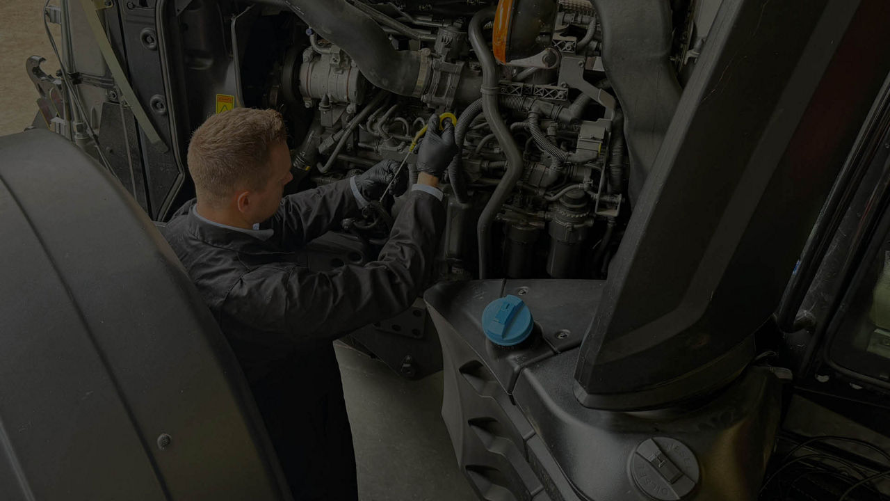 Mechanic working on tractor engine