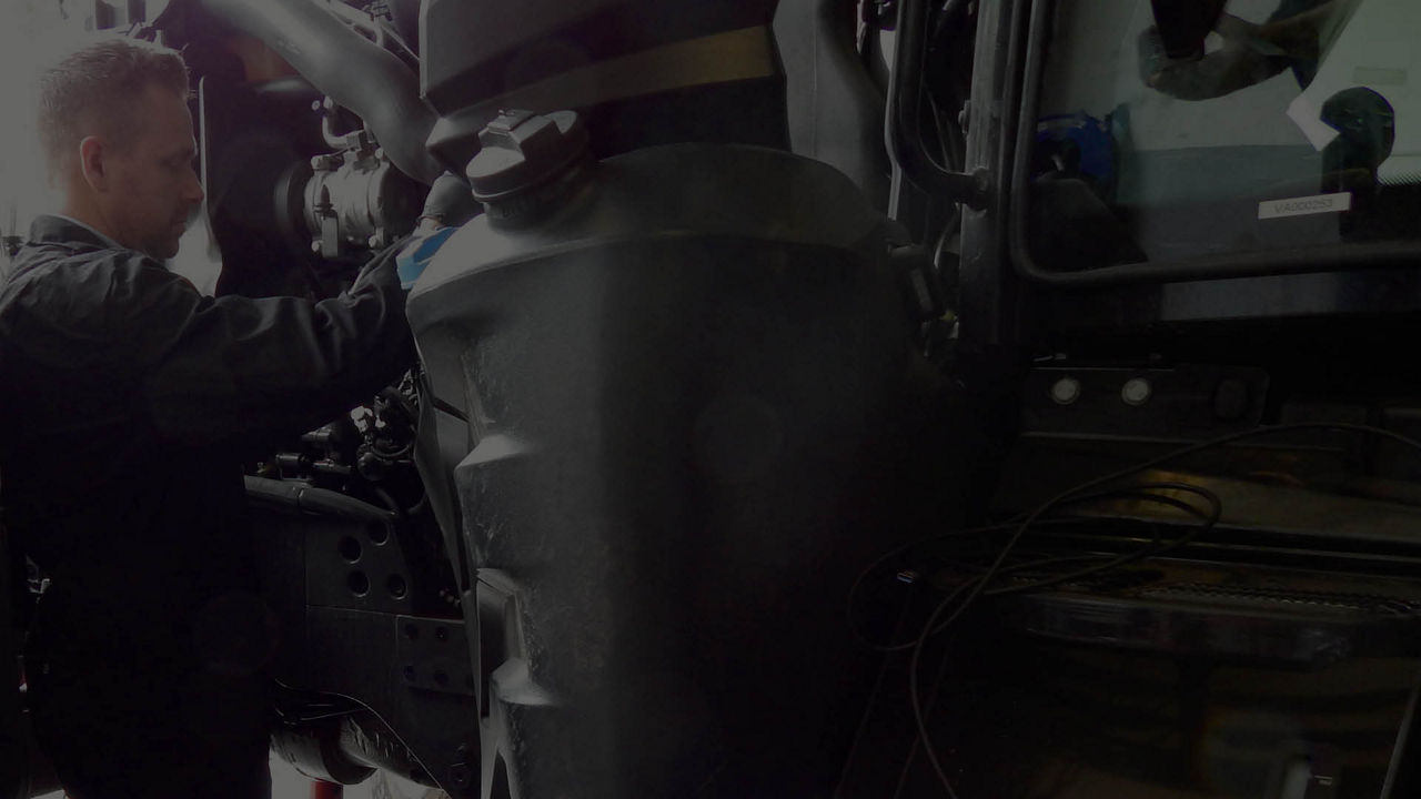 Mechanic working on heavy-duty vehicle engine