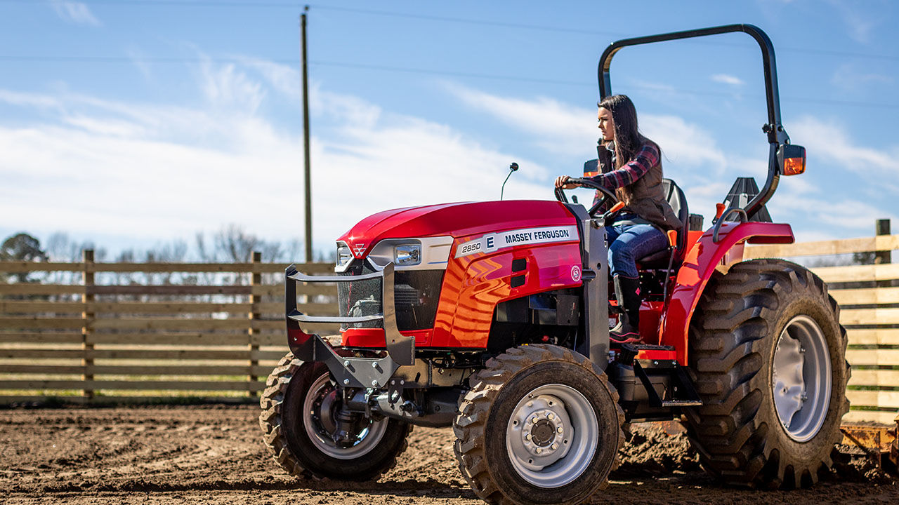 woman driving a Massey ferguson 2800E series tractor