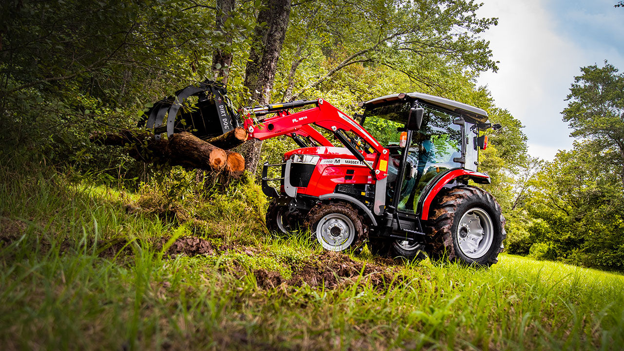 man hauling lumber with a Massey ferguson 2800M series tractor