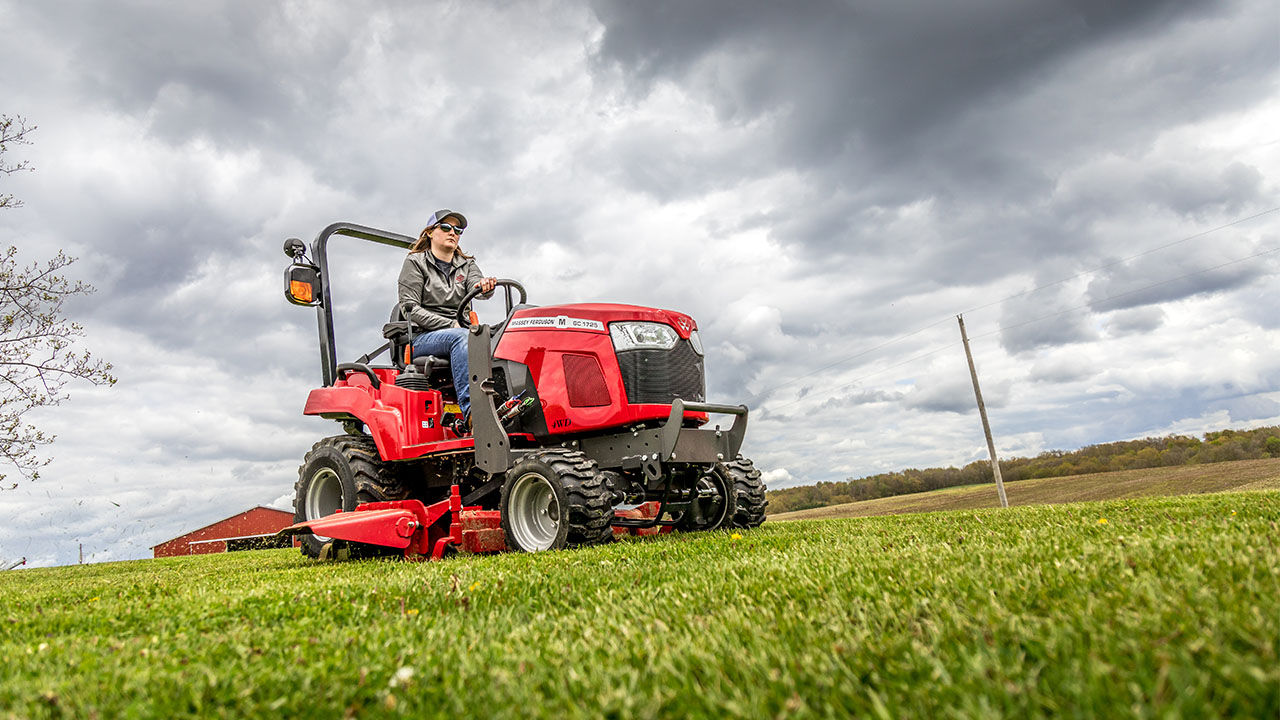 woman driving a massey ferguson GC1700 series tractor