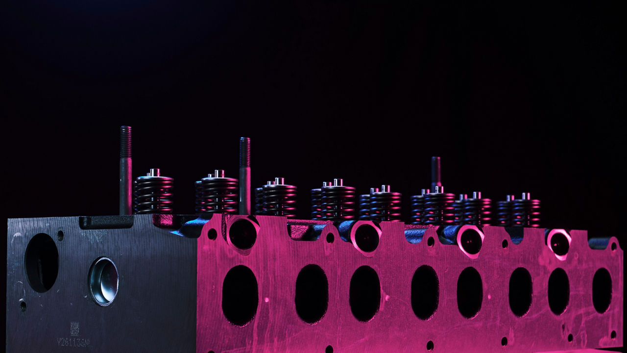 Two technicians working on an engine block