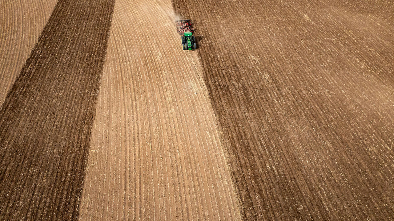 Aerial view of a tractor running a disc