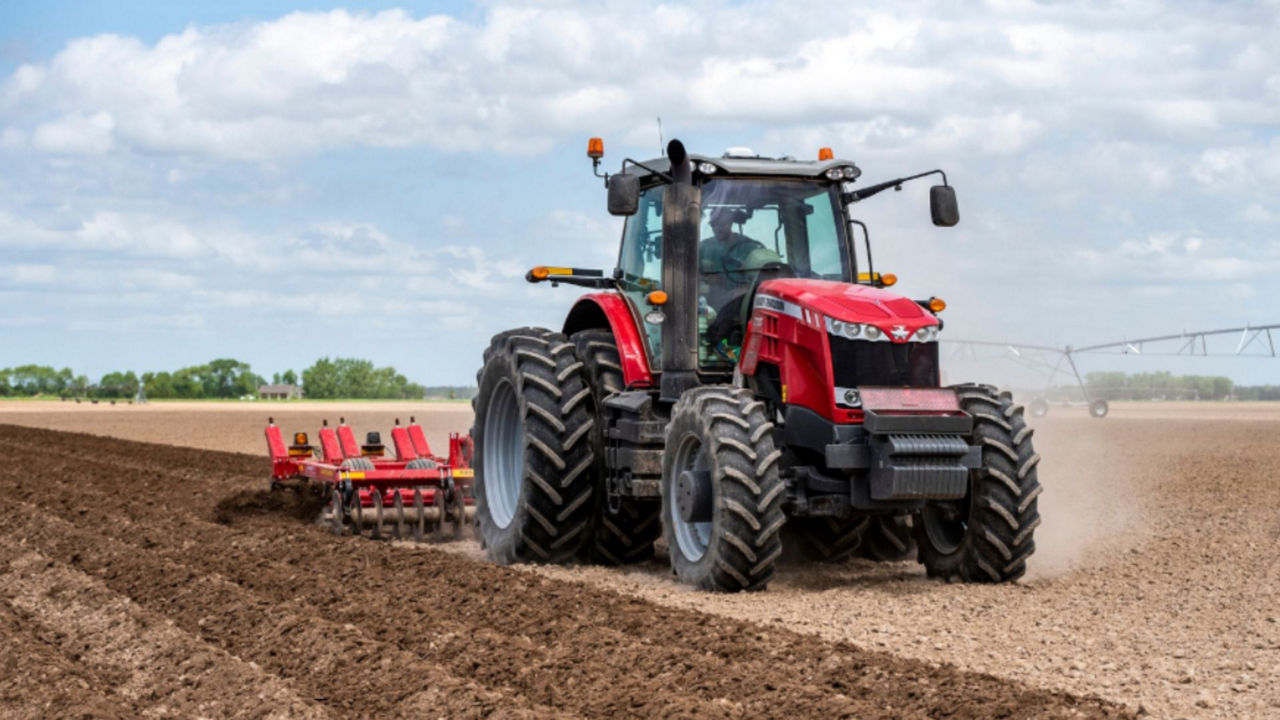 A tractor in Midwest works direct in field with pivot