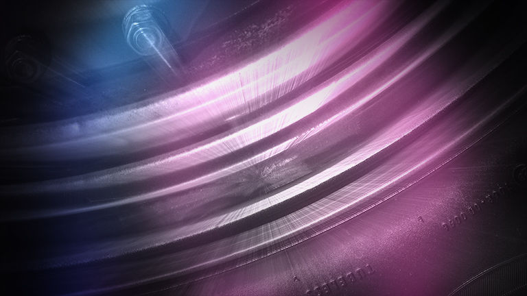 An extreme close up of a tyre in purple light
