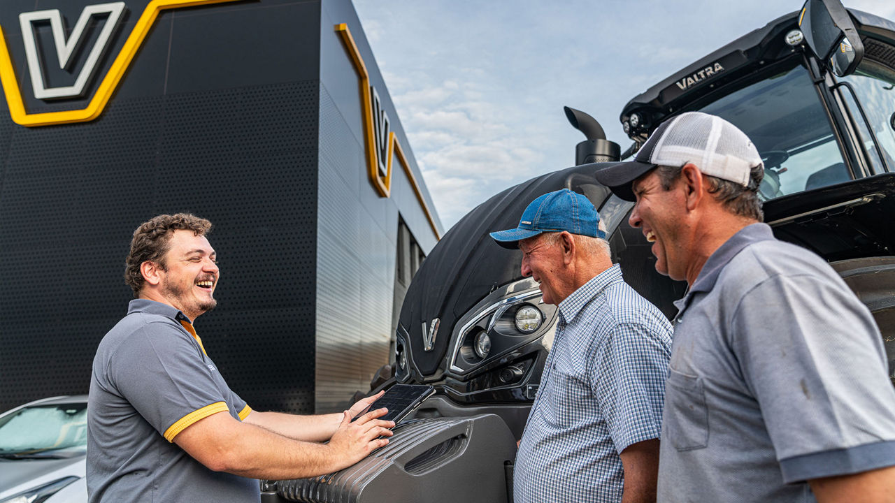 Dealer and farmers in front of Valtra tractor