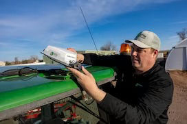 The NAV-960 receiver on the roof of a tractor.