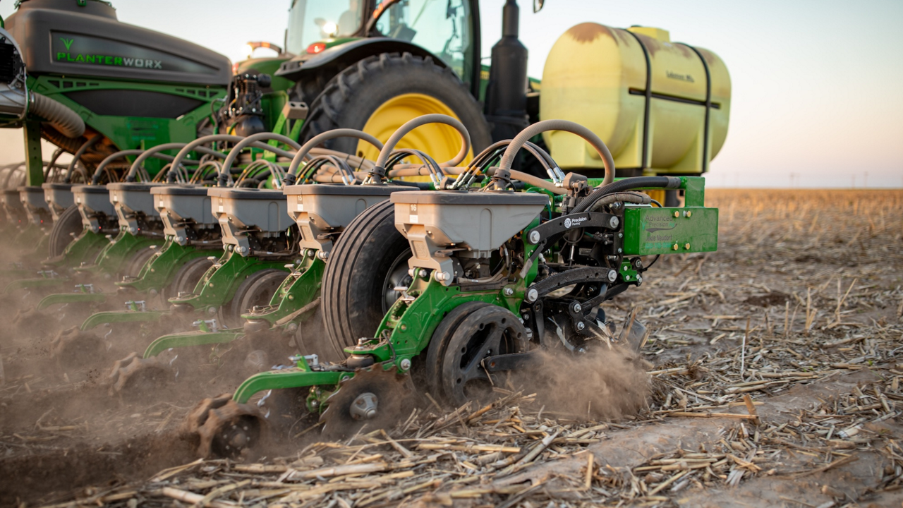 A tractor and planter in the field