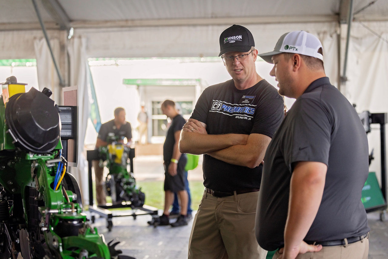 PTx employees visits with farmer about latest technology at Farm Progress Show