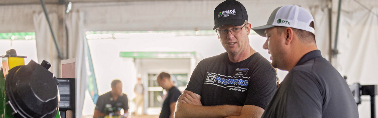 PTx employee and farmer talk at Farm Progress Show