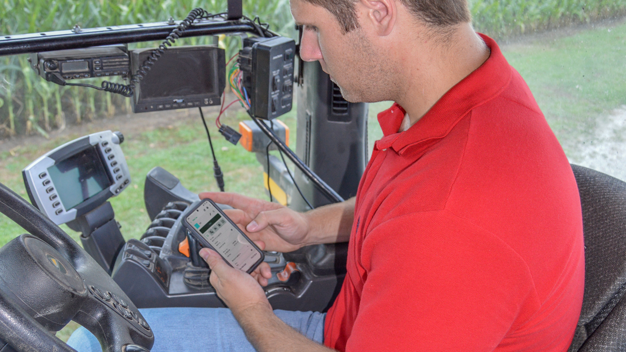A man accesses PTx FarmENGAGE work orders on a cell phone